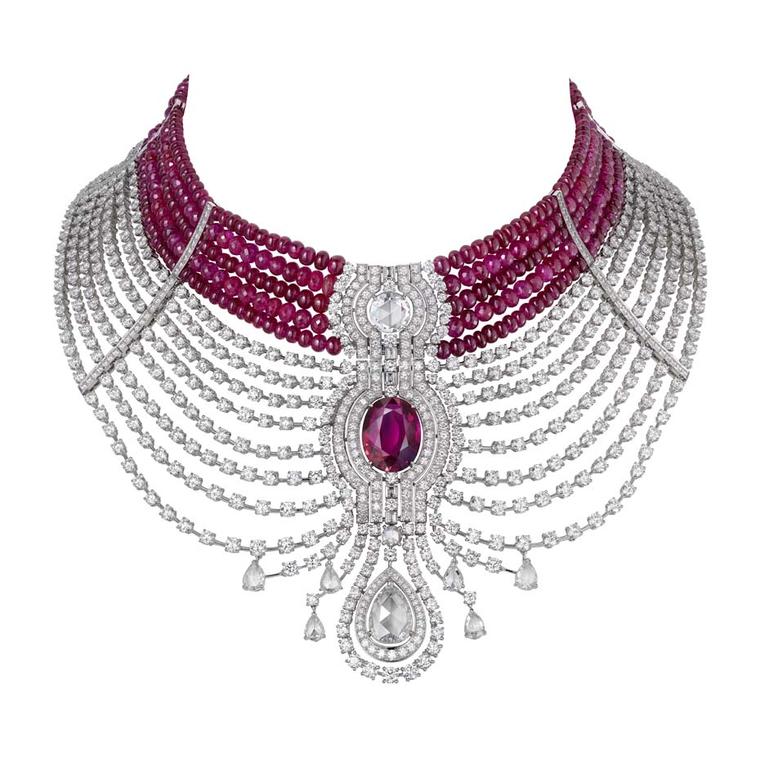 Cartier Reine Makéda necklace in platinum, set with a 15.29 carat oval-shaped ruby from Mozambique, alongside rose-cut and pear-shaped diamonds, and cabochon-cut ruby beads. The ruby choker can be detached and worn separately from the diamond necklace.